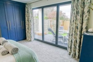 Madrona_Valley_Anglesey_double_bedroom_ensuite_french-windows_garden-view_3_1920x1080 Madrona_Valley_Anglesey_double_bedroom_ensuite_french-windows_garden-view_3_1920x1080